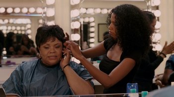 Movie still from “Madea Goes to Jail” (2009), directed by Tyler Perry – A woman getting her hair cut by a stylist; Medium shot, Over the shoulder angle