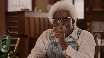 Movie still from “Madea Goes to Jail” (2009), directed by Tyler Perry – An older man with a white beard is pointing; Medium shot, Low angle