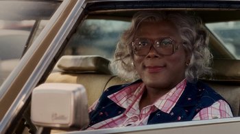 Movie still from “Madea Goes to Jail” (2009), directed by Tyler Perry – A person sitting in the back seat of a car; Close Up shot, Low angle