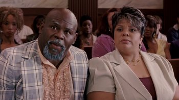 Movie still from “Madea Goes to Jail” (2009), directed by Tyler Perry – A man and a woman sitting next to each other in front of a crowd; Close Up shot, High angle