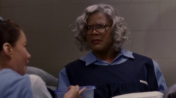 Movie still from “Madea Goes to Jail” (2009), directed by Tyler Perry – A person with a cell phone in their hand; Close Up shot, Over the shoulder angle