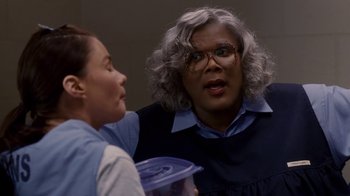Movie still from “Madea Goes to Jail” (2009), directed by Tyler Perry – Two women talking to each other while holding a container; Close Up shot, Over the shoulder angle