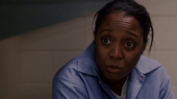 Movie still from “Madea Goes to Jail” (2009), directed by Tyler Perry – A woman in a blue shirt is looking at the camera; Close Up shot, High angle