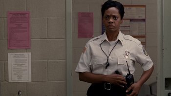 Movie still from “Madea Goes to Jail” (2009), directed by Tyler Perry – A police officer is holding a walkie talkie in her hand; Close Up shot, Low angle