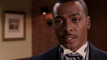 Movie still from “Madea Goes to Jail” (2009), directed by Tyler Perry – A person wearing a suit and tie; Close Up shot, Over the shoulder angle
