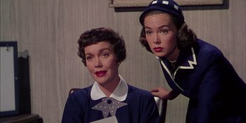 Movie still from “Magnificent Obsession” (1954), directed by Douglas Sirk – Two women are sitting next to each other; Close Up shot, Low angle