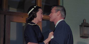 Movie still from “Magnificent Obsession” (1954), directed by Douglas Sirk – An older man and a younger woman looking at each other; Medium shot, Low angle