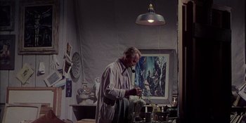 Movie still from “Magnificent Obsession” (1954), directed by Douglas Sirk – An older man is painting in his studio; Medium shot, Low angle