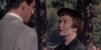 Movie still from “Magnificent Obsession” (1954), directed by Douglas Sirk – An older woman wearing a black hat talking to a young man; Close Up shot, Over the shoulder angle