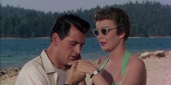 Movie still from “Magnificent Obsession” (1954), directed by Douglas Sirk – A man and a woman looking at each other on the beach; Close Up shot, Low angle