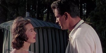 Movie still from “Magnificent Obsession” (1954), directed by Douglas Sirk – A man and a woman talking to each other outside; Medium shot, Low angle