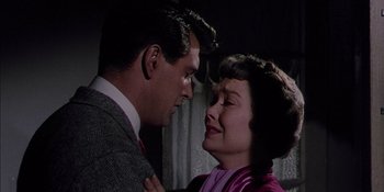 Movie still from “Magnificent Obsession” (1954), directed by Douglas Sirk – A man and a woman standing next to each other; Close Up shot, Low angle