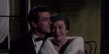 Movie still from “Magnificent Obsession” (1954), directed by Douglas Sirk – A man and a woman standing next to each other; Close Up shot, Low angle