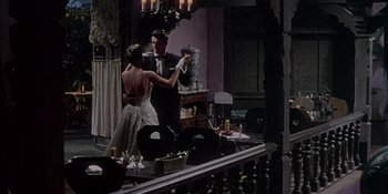 Movie still from “Magnificent Obsession” (1954), directed by Douglas Sirk – A man and a woman dancing in front of a mirror; Wide shot, High angle