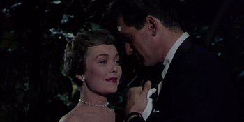 Movie still from “Magnificent Obsession” (1954), directed by Douglas Sirk – A man and a woman in formal wear posing for a picture; Close Up shot, Low angle