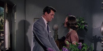 Movie still from “Magnificent Obsession” (1954), directed by Douglas Sirk – A man and a woman standing next to each other in a room; Medium shot, Over the shoulder angle