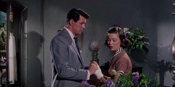 Movie still from “Magnificent Obsession” (1954), directed by Douglas Sirk – A man and a woman standing next to each other; Medium shot, Low angle