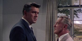 Movie still from “Magnificent Obsession” (1954), directed by Douglas Sirk – A man in a suit and tie talking to another man; Close Up shot, Low angle