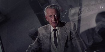 Movie still from “Magnificent Obsession” (1954), directed by Douglas Sirk – An older man wearing a suit and tie; Close Up shot, Over the shoulder angle