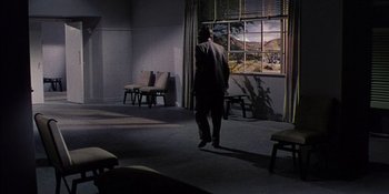 Movie still from “Magnificent Obsession” (1954), directed by Douglas Sirk – A man standing in front of an open window; Wide shot, High angle