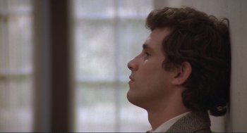 Movie still from “Making Love” (1982), directed by Arthur Hiller – A person wearing a suit looking up; Close Up shot, Low angle
