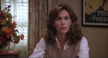 Movie still from “Making Love” (1982), directed by Arthur Hiller – A woman with long brown hair sitting in a room; Close Up shot, Over the shoulder angle