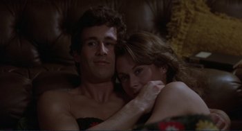 Movie still from “Making Love” (1982), directed by Arthur Hiller – A man and a woman sitting on a couch together; Close Up shot, Low angle