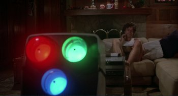 Movie still from “Making Love” (1982), directed by Arthur Hiller – Two people sitting in a living room talking on the phone; Medium shot, Low angle