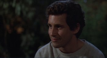 Movie still from “Making Love” (1982), directed by Arthur Hiller – A person smiling at the camera; Close Up shot, Over the shoulder angle