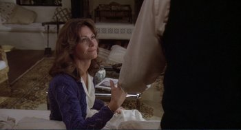 Movie still from “Making Love” (1982), directed by Arthur Hiller – A woman sitting on the ground in a living room; Medium shot, Over the shoulder angle