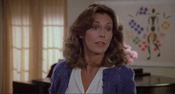 Movie still from “Making Love” (1982), directed by Arthur Hiller – A person with long hair wearing a sweater; Close Up shot, Over the shoulder angle