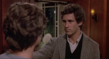 Movie still from “Making Love” (1982), directed by Arthur Hiller – A man in a suit and tie talking to another man in front of a window; Close Up shot, Over the shoulder angle