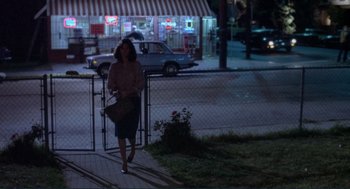 Movie still from “Making Love” (1982), directed by Arthur Hiller – A woman walking down a sidewalk at night; Wide shot, Over the shoulder angle