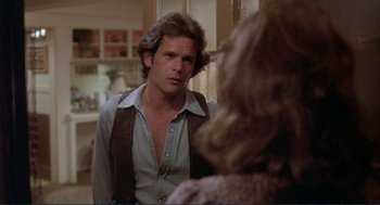 Movie still from “Making Love” (1982), directed by Arthur Hiller – A man is looking at a woman in a room; Close Up shot, Over the shoulder angle