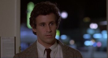 Movie still from “Making Love” (1982), directed by Arthur Hiller – A person wearing a suit and tie; Close Up shot, Low angle