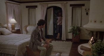Movie still from “Making Love” (1982), directed by Arthur Hiller – A man sitting on the floor in front of a woman; Wide shot, High angle
