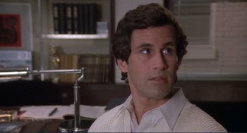 Movie still from “Making Love” (1982), directed by Arthur Hiller – A man that is sitting in a room; Close Up shot, Over the shoulder angle