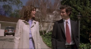 Movie still from “Making Love” (1982), directed by Arthur Hiller – A man and a woman standing next to each other outside; Medium shot, Low angle