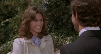 Movie still from “Making Love” (1982), directed by Arthur Hiller – A woman in a white jacket talking to a man in a suit; Close Up shot, Over the shoulder angle