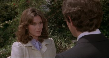 Movie still from “Making Love” (1982), directed by Arthur Hiller – A woman in a white coat and a man in a suit talking; Close Up shot, Over the shoulder angle