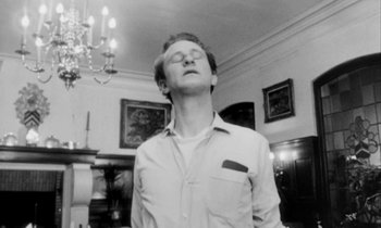 Movie still from “Man Bites Dog” (1992), directed by Benoît Poelvoorde – A black and white photo of a man with his eyes closed; Close Up shot, Low angle