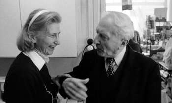Movie still from “Man Bites Dog” (1992), directed by Benoît Poelvoorde – An older man and a younger woman are talking to each other; Medium shot, Low angle