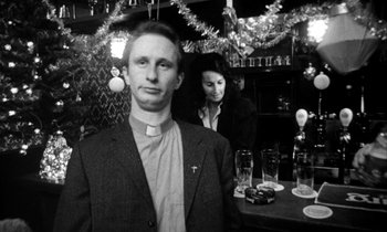 Movie still from “Man Bites Dog” (1992), directed by Benoît Poelvoorde – A man and a woman standing in front of a bar; Close Up shot, Low angle