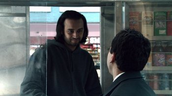 Movie still from “Man Push Cart” (2005), directed by Ramin Bahrani – A man with long black hair talking to another man in a suit; Medium shot, Over the shoulder angle