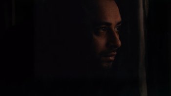 Movie still from “Man Push Cart” (2005), directed by Ramin Bahrani – A person's face in the dark; Close Up shot, Low angle