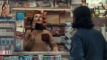 Movie still from “Man Push Cart” (2005), directed by Ramin Bahrani – A woman is looking in the mirror in a store; Medium shot, Over the shoulder angle