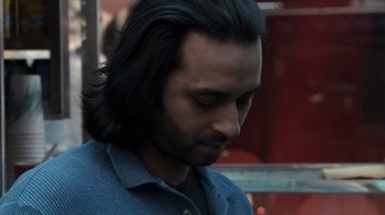 Movie still from “Man Push Cart” (2005), directed by Ramin Bahrani – A person with long black hair; Close Up shot, Over the shoulder angle