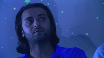 Movie still from “Man Push Cart” (2005), directed by Ramin Bahrani – A man with long black hair looking up at the sky; Close Up shot, Low angle