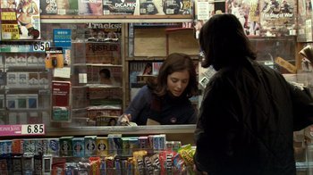 Movie still from “Man Push Cart” (2005), directed by Ramin Bahrani – A woman standing in front of a counter in a store; Medium shot, Over the shoulder angle