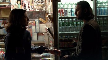 Movie still from “Man Push Cart” (2005), directed by Ramin Bahrani – A man and a woman are talking in front of a store window; Medium shot, Over the shoulder angle